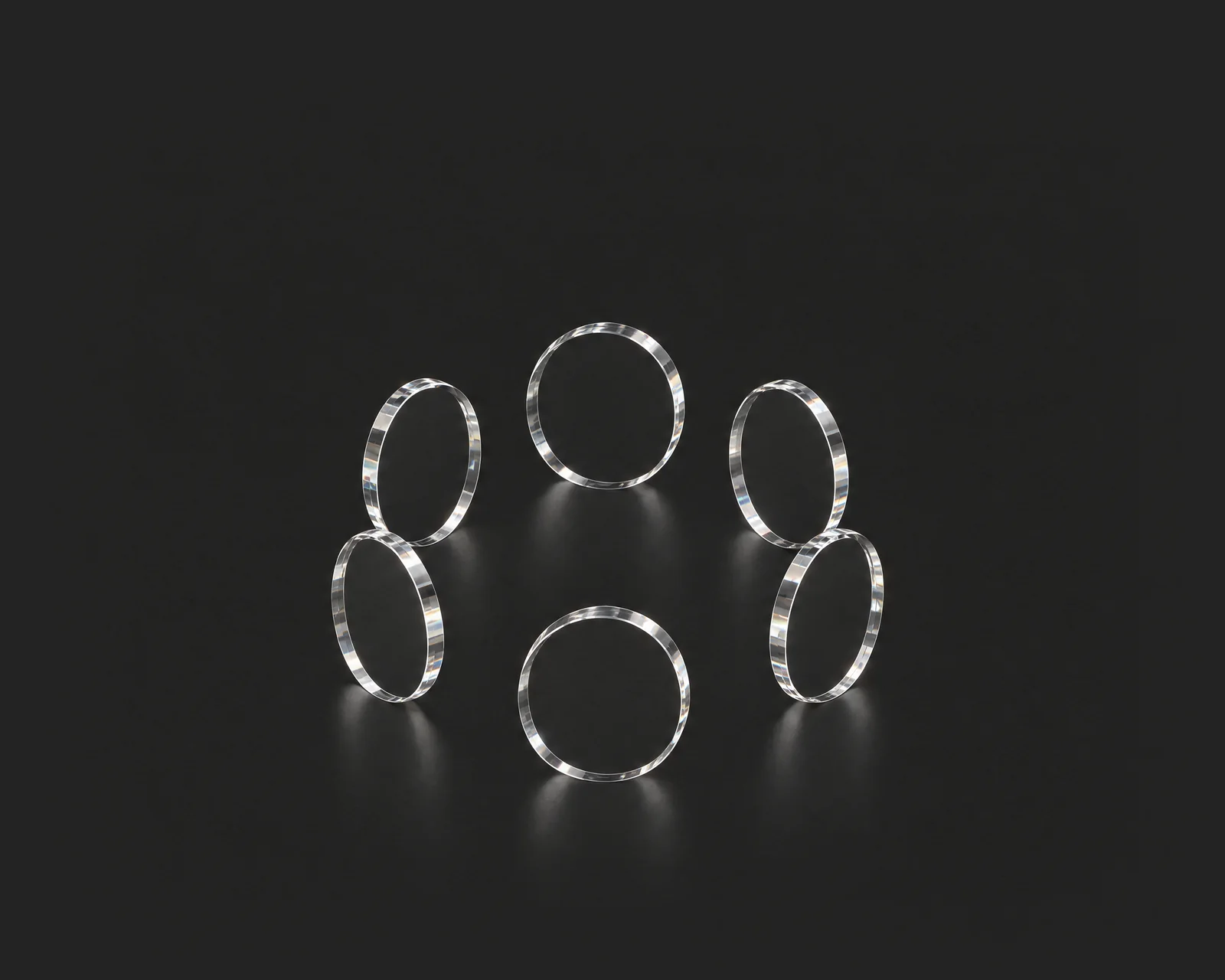 A glass sphere inside a glass ring on a dark ground, running on its own